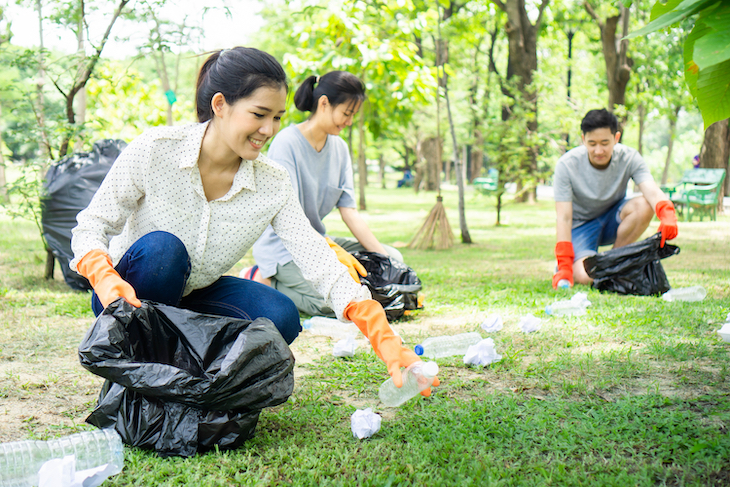 Team of volunteers collecting garbage in public park